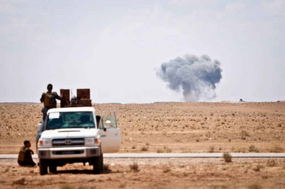 Syrian Democratic Forces watch as a coalition airstrike hits its target on a known Islamic State of Iraq and Syria location near the Iraq-Syria border, May 13, 2018. (DoD photo by Army Staff Sgt. Timothy R. Koster)