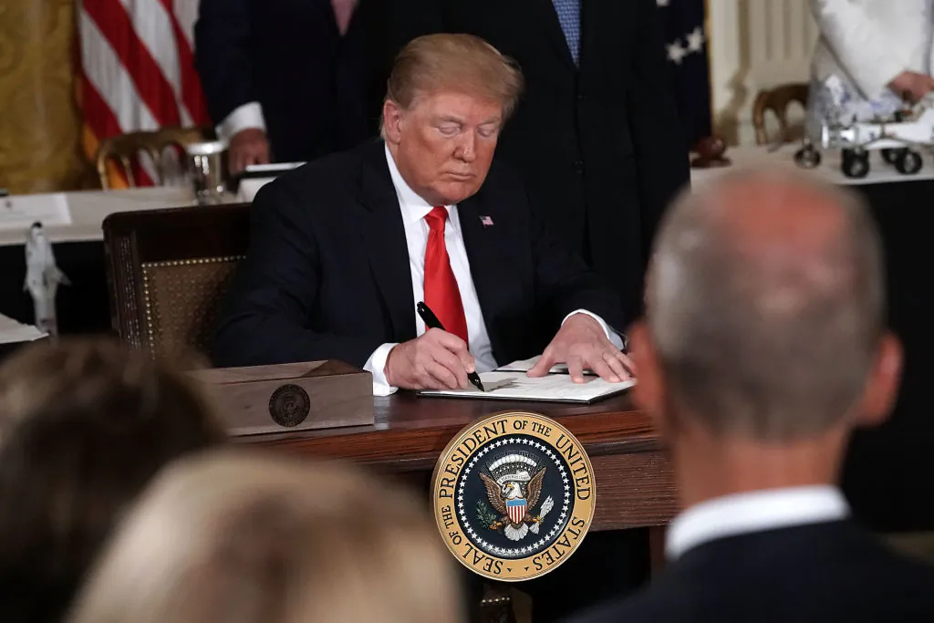 U.S. President Donald Trump signs an executive order during a meeting of the National Space Council at the East Room of the White House June 18, 2018, in Washington, D.C. (Alex Wong/Getty Images)