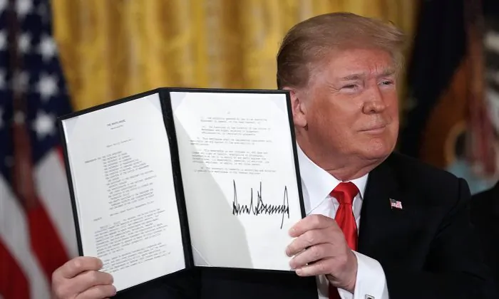 President Donald Trump holds up an executive order for the creation of a Space Force, during a meeting of the National Space Council at the East Room of the White House June 18, 2018 in Washington. (Alex Wong/Getty Images)