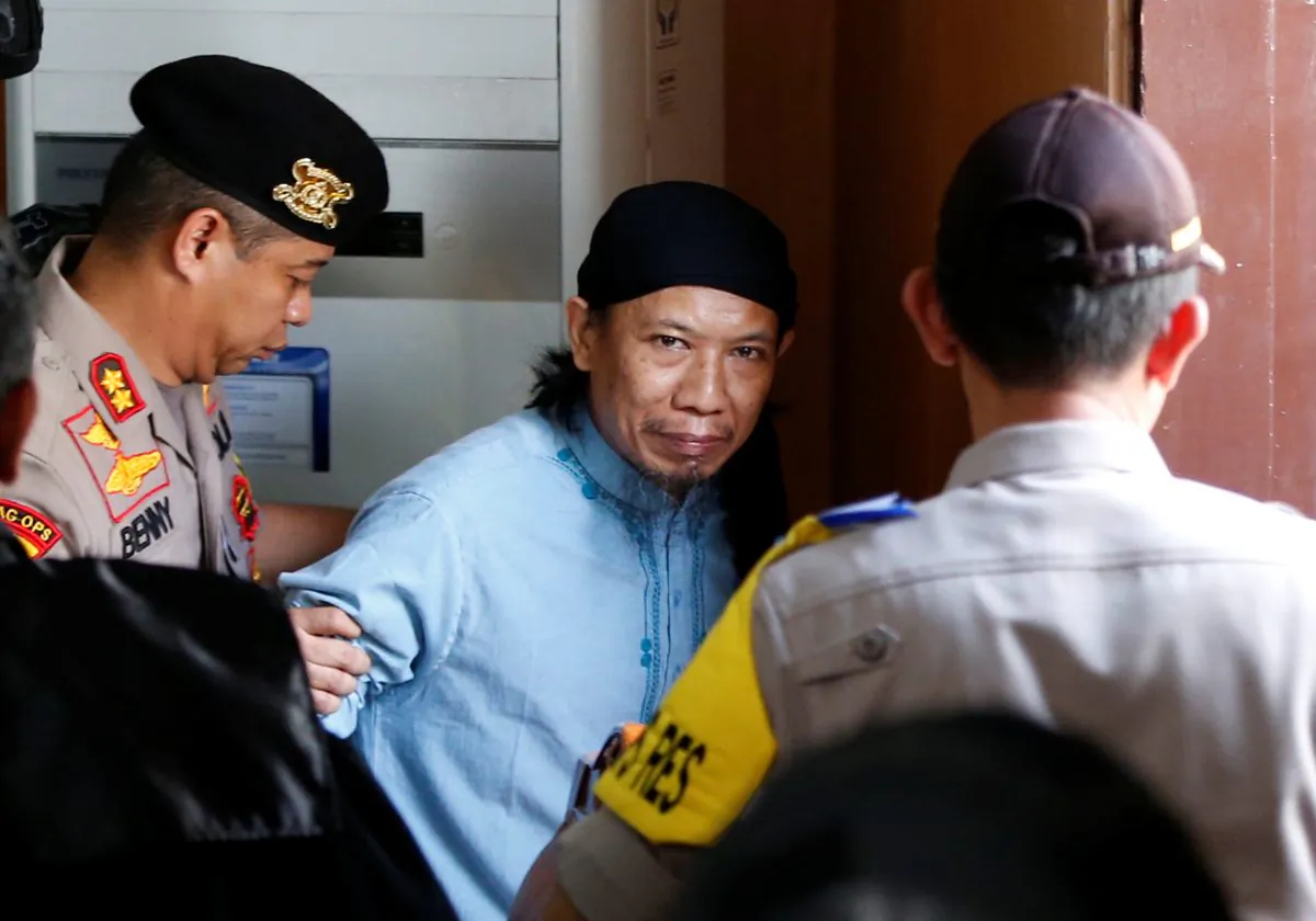 Islamic cleric Aman Abdurrahman leaves a court following his verdict in Jakarta, Indonesia, June 22, 2018. (Reuters/Darren Whiteside)