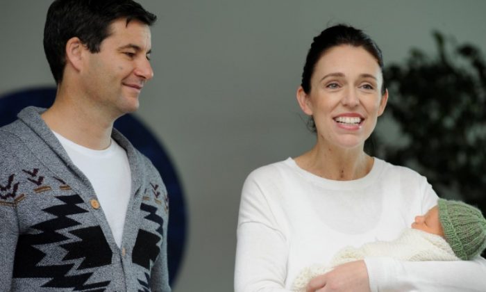 New Zealand Prime Minister Jacinda Ardern carries her newborn baby Neve Te Aroha Ardern Gayford with her partner Clarke Gayford as she walks out of the Auckland Hospital in New Zealand, June 24, 2018. (Reuters/Ross Land)