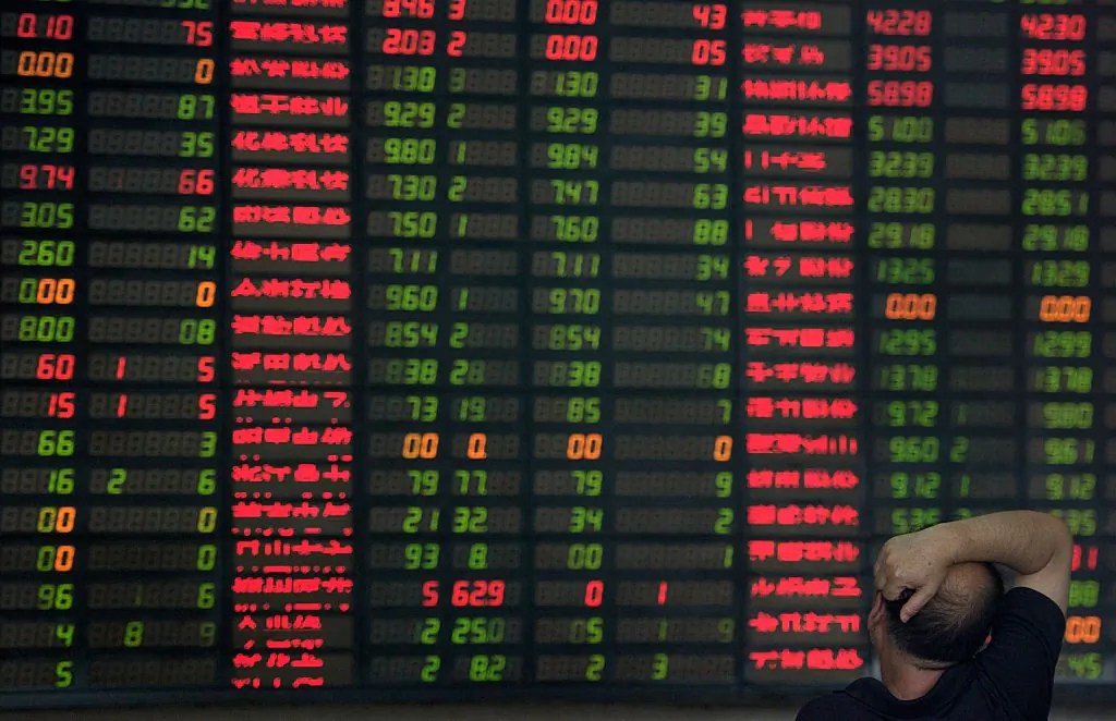 An investor monitors screens showing stock market movements at a brokerage house in Shanghai, on Sept. 1, 2015. (Johannes Eisele/AFP/Getty Images)