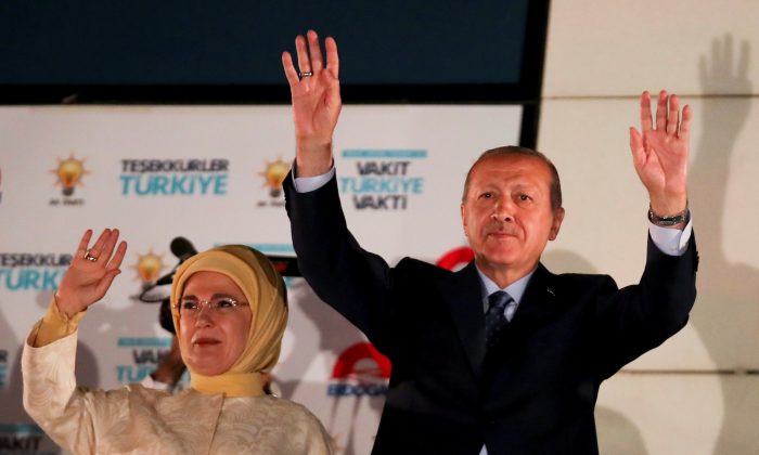 Turkish President Tayyip Erdogan and his wife Emine Erdogan greet supporters gathered in front of the AKP headquarters in Ankara, Turkey June 25, 2018. (Reuters/Umit Bektas)