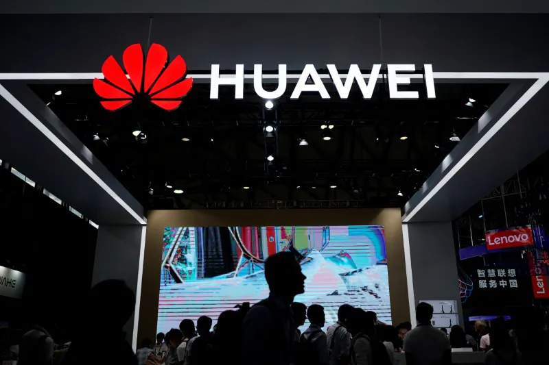 People walk past a sign board of Huawei at CES (Consumer Electronics Show) Asia 2018 in Shanghai, China on June 14, 2018. (Aly Song/Reuters)