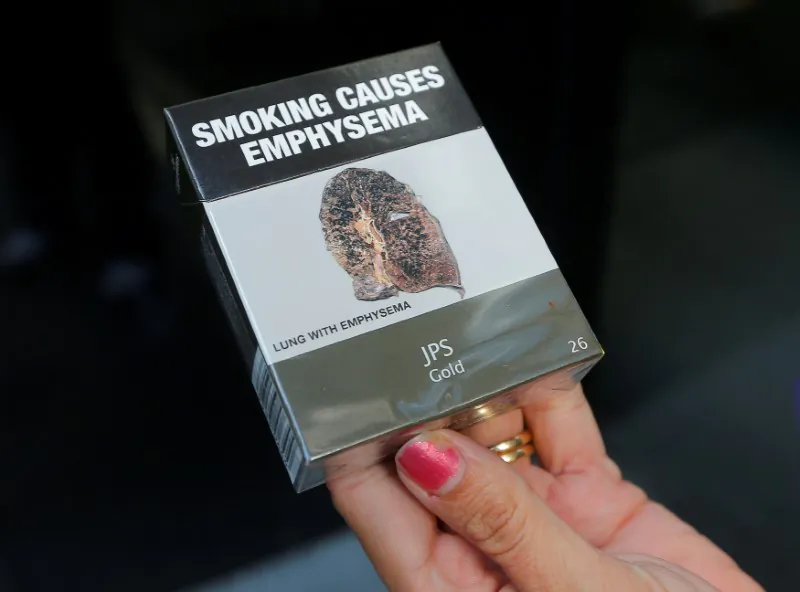 A photo illustration shows restrictive tobacco packaging on cigarettes outside a Sydney office building in Australia, May 5, 2017. (Reuters/Jason Reed)