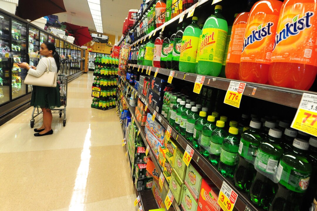 A woman shops for frozen foods on an aisle across from sodas and other sugary drinks for sale at a superrmarket in Monterey Park, California, on June 18, 2014. (Frederic J. Brown/AFP/Getty Images)