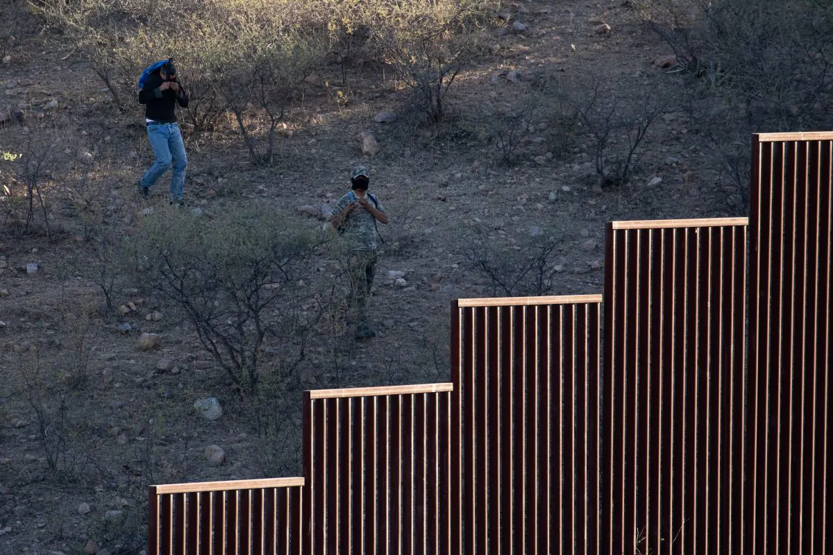 Two suspected cartel lookouts mask their faces in Nogales, Mexico, at the U.S.-Mexico border on May 23, 2018. (Samira Bouaou/The Epoch Times)
