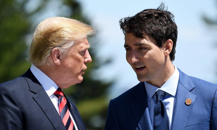 Prime Minister of Canada Justin Trudeau (R) speaks with U.S. President Donald Trump during the G7 official welcome at Le Manoir Richelieu on day one of the G7 meeting on June 8, 2018 in Quebec City, Canada. (Leon Neal/Getty Images)
