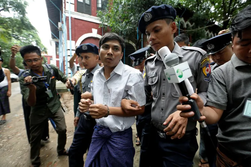 Detained Reuters journalist Kyaw Soe Oo is escorted by police while leaving Insein court in Yangon, Burma (also known as Myanmar), on July 2, 2018. (Reuters/Ann Wang)
