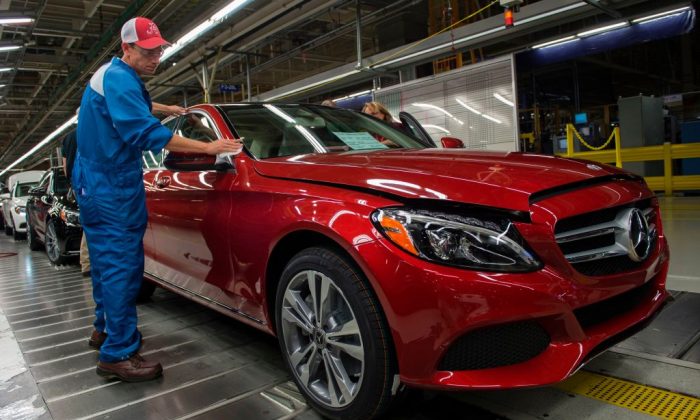 An employee does final inspections on a Mercedes-Benz C-Class at the Mercedes-Benz US International factory in Vance, Alabama on June 8, 2017. (ANDREW CABALLERO-REYNOLDS/AFP/Getty Images)