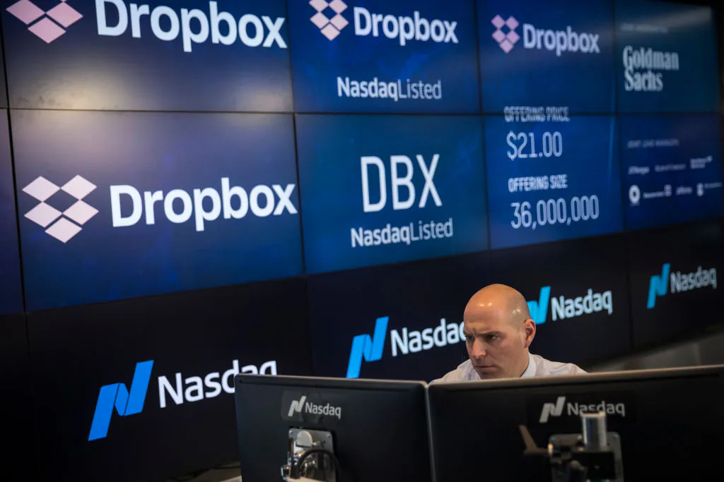 Jay Heller, Head of IPO Execution at Nasdaq, monitors a computer screen as trading starts on Dropbox's initial public offering at Nasdaq MarketSite, in New York City on March 23, 2018. (Drew Angerer/Getty Images)