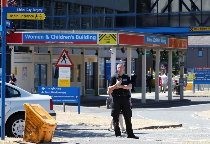 A security officer stands outside the entrance to the Countess of Chester Hospital, Chester, United Kingdom, on July 3, 2018. (Andrew Yates/Reuters)