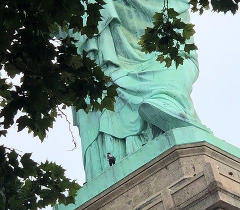 A protester is seen on the Statue of Liberty in New York, New York, U.S., July 4, 2018 in this picture obtained from social media. (Danny Owens/Reuters)
