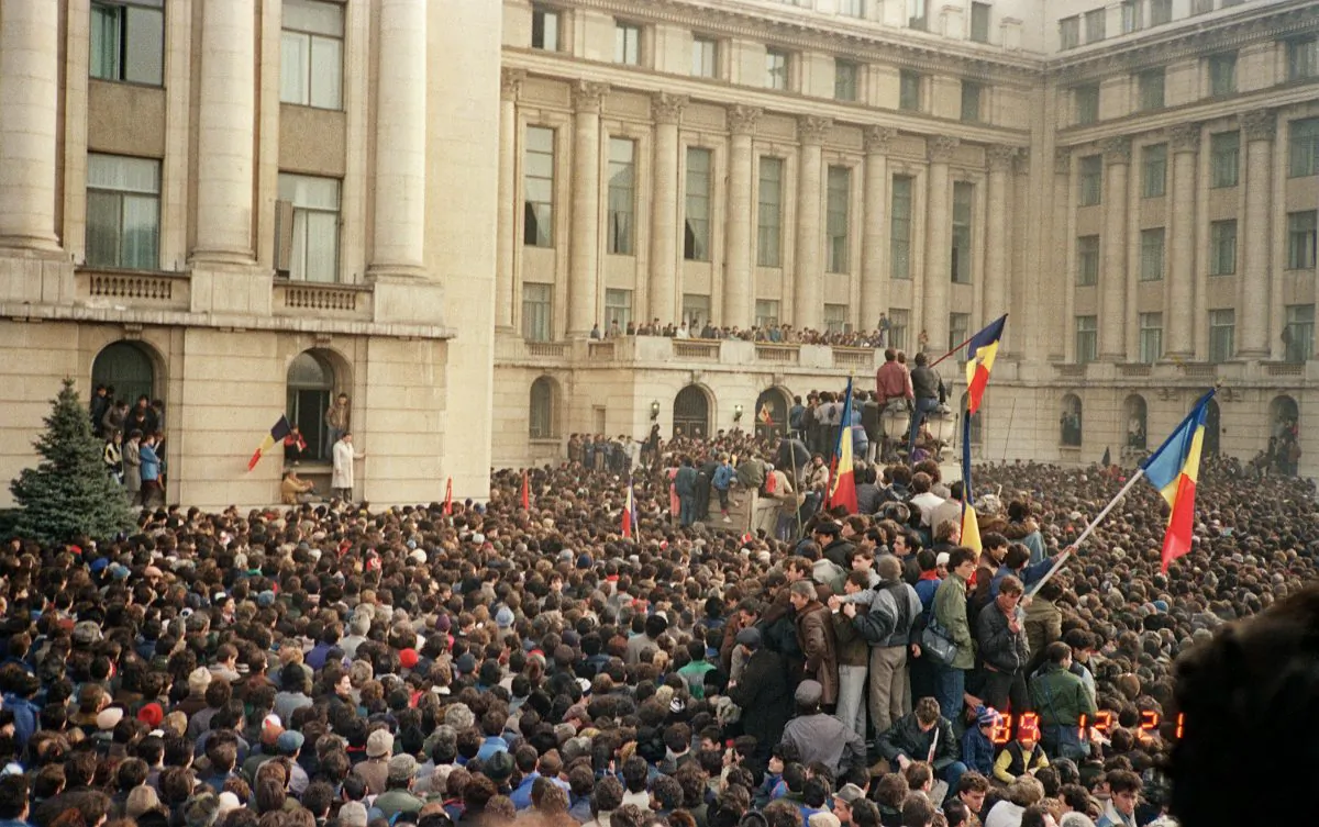 Bucharest citizens wave Romanian flags as they stage an anti-communist demonstration at the Republic Square on Dec. 21, 1989, shortly before the fall of the communist regime. (Photo credit should read AFP/Getty Images)