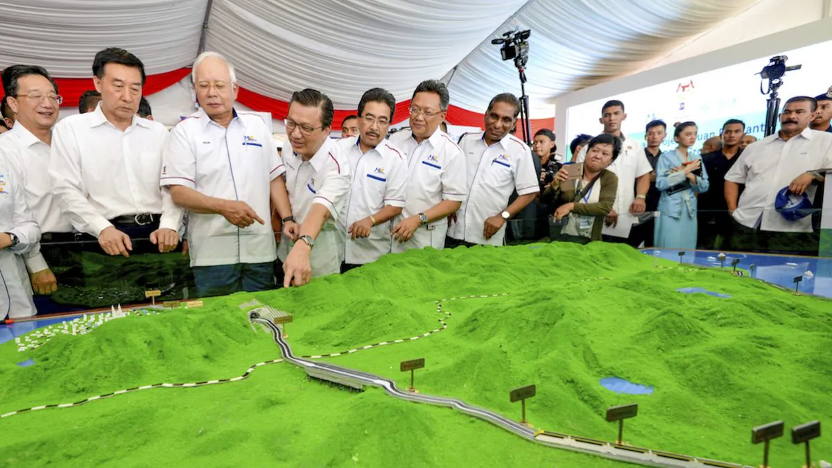 In Sept. 8, 2017, Malaysia former Prime Minster Najib Razak (3rd L) looks at modals of East Coast Rail Link during the project launching in Kuantan, Malaysia. (AP Photo)