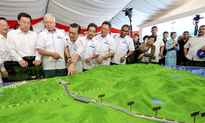 In Sept. 8, 2017, Malaysia former Prime Minster Najib Razak (3rd L) looks at modals of East Coast Rail Link during the project launching in Kuantan, Malaysia. (AP Photo)