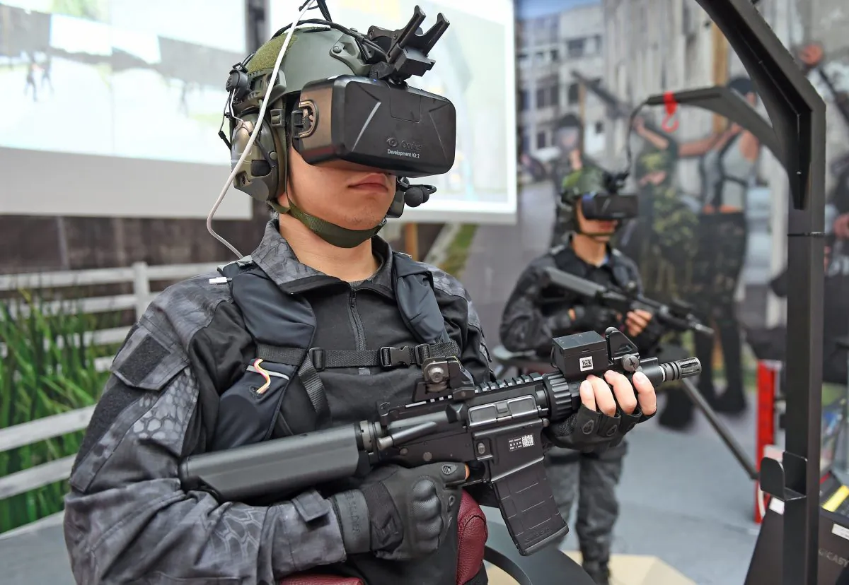 Armed military soldiers display the homemade Shooting Simulation System during a press conference of the 2015 Taipei Aerospace and Defense Technology Exhibition at the World Trade Center in Taipei, Taiwan, on Aug. 12, 2015. (Sam Yeh/AFP/Getty Images)