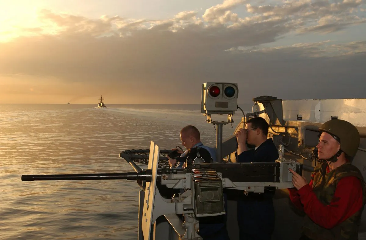 In this file photo handed out by the U.S. Navy sailors man a .50-caliber machine gun onboard the USS Kitty Hawk in the Strait of Hormuz. (U.S. Navy/Photographer's Mate 3rd Class Todd Frantom/Getty Images)