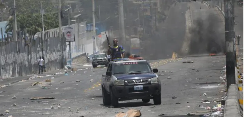 A Haitian National Police car drives next to barricades on a street in Port-au-Prince, Haiti, July 8, 2018. REUTERS/Andres Martinez Casares