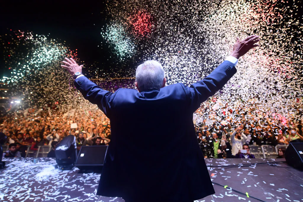 Newly elected Mexico's President Andres Manuel Lopez Obrador (C), running for "Juntos haremos historia" party, cheers his supporters at the Zocalo Square after winning general elections, in Mexico City, on July 1, 2018. (Pedro Pardo/AFP/Getty Images)