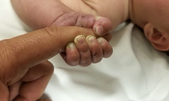 A 5-month-old infant with dirt under his fingernails.(Missoula County Sheriff's Office)