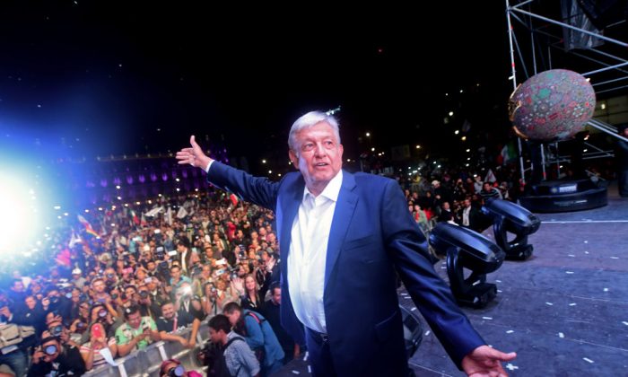 Newly elected Mexico's President Andrés Manuel López Obrador, running for the "Juntos haremos historia" party, cheers his supporters at the Zocalo Square after winning the general election, in Mexico City, Mexico on July 1, 2018. (PEDRO PARDO/AFP/Getty Images)