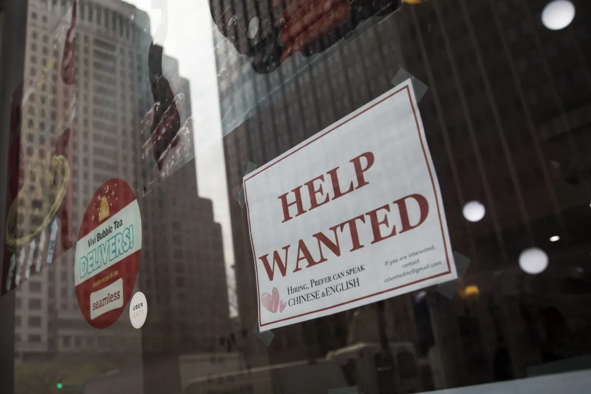 A “help wanted” sign hangs on a window of a restaurant in Lower Manhattan, May 4, 2018 in New York City. (Drew Angerer/Getty Images)