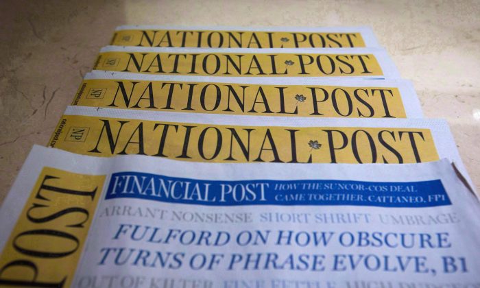 Copies of the Postmedia-owned National Post are displayed at a hotel in Burnaby, B.C. (The Canadian Press/Darryl Dyck)