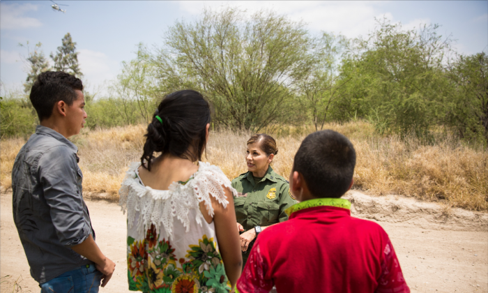 Border Patrol agent Marlene Castro speaks to a group of unaccompanied minors who just crossed illegally from Mexico into the United States in Hidalgo County, Texas, on May 26, 2017. (Benjamin Chasteen/The Epoch Times)