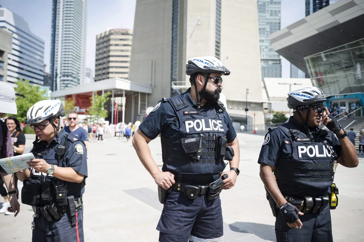 Police are seen in Toronto, on Thursday, July 12, 2018. (Christopher Katsarov/The Canadian Press).