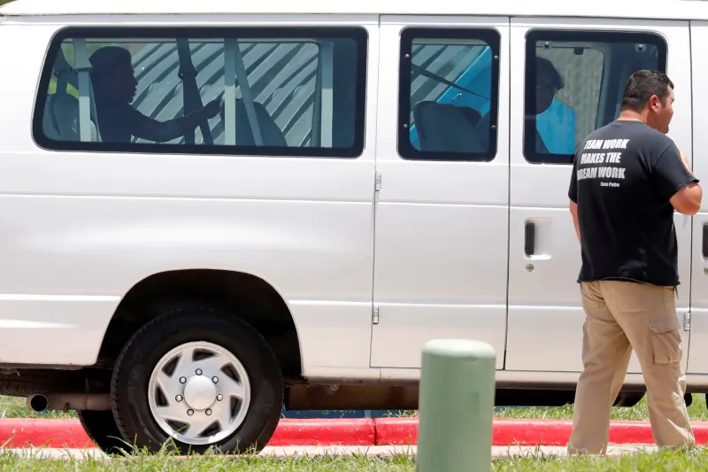 A minor sits in the back of a van as he is transported to Casa Esperanza, a federal contracted shelter in Brownsville, Texas, on July 11, 2018. (Carlos Barria/Reuters)