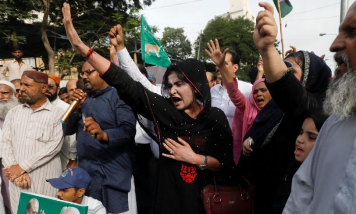 Supporters of the Pakistan Muslim League - Nawaz (PML-N) chant slogans against the arrest of their activists in Lahore who were on their way to welcome ousted Prime Minister Nawaz Sharif and his daughter Maryam, during a protest in Karachi, Pakistan July 13, 2018. (Akhtar Soomro/Reuters)
