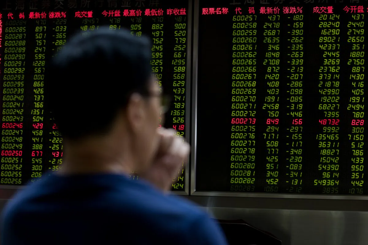 A man sits in front of a screen showing stock prices at a securities brokerage in Beijing on July 11. (Nicolas Asfouri/ AFP/Getty Images)