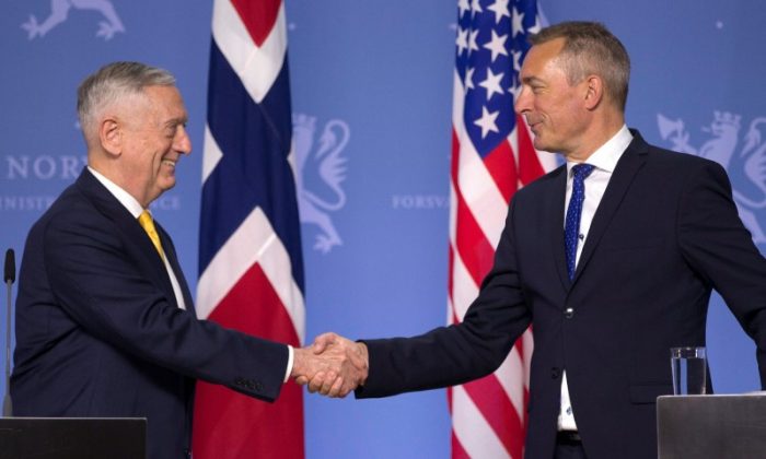 US Secretary of Defence James Mattis shakes hands with Norwegian Minister of Defense Frank Bakke-Jensen during a press conference at the Ministry of Defence in Olso, Norway on July 14, 2018. (NTB Scanpix/Trond Reidar Teigen/via Reuters)