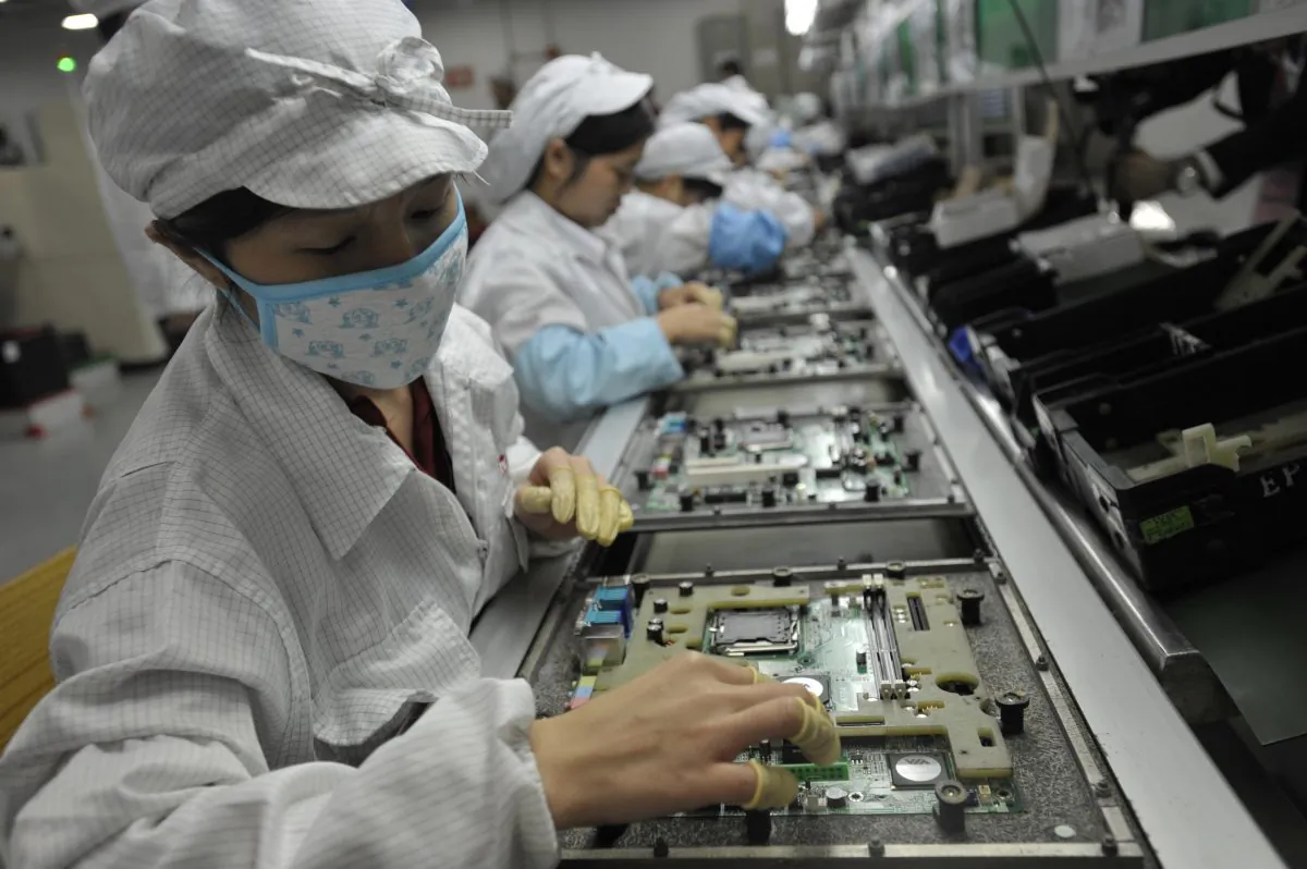 In this undated file photo, Chinese workers are shown in a Foxconn factory in Shenzhen, in southern China's Guangdong Province. (STR/AFP/GettyImages)