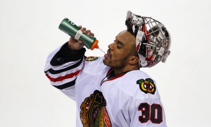 Ray Emery has a drink of water during a break in their game against the Calgary Flames during the third period of their NHL hockey game in Calgary, Alberta, Feb. 2, 2013. (REUTERS/Todd Korol)