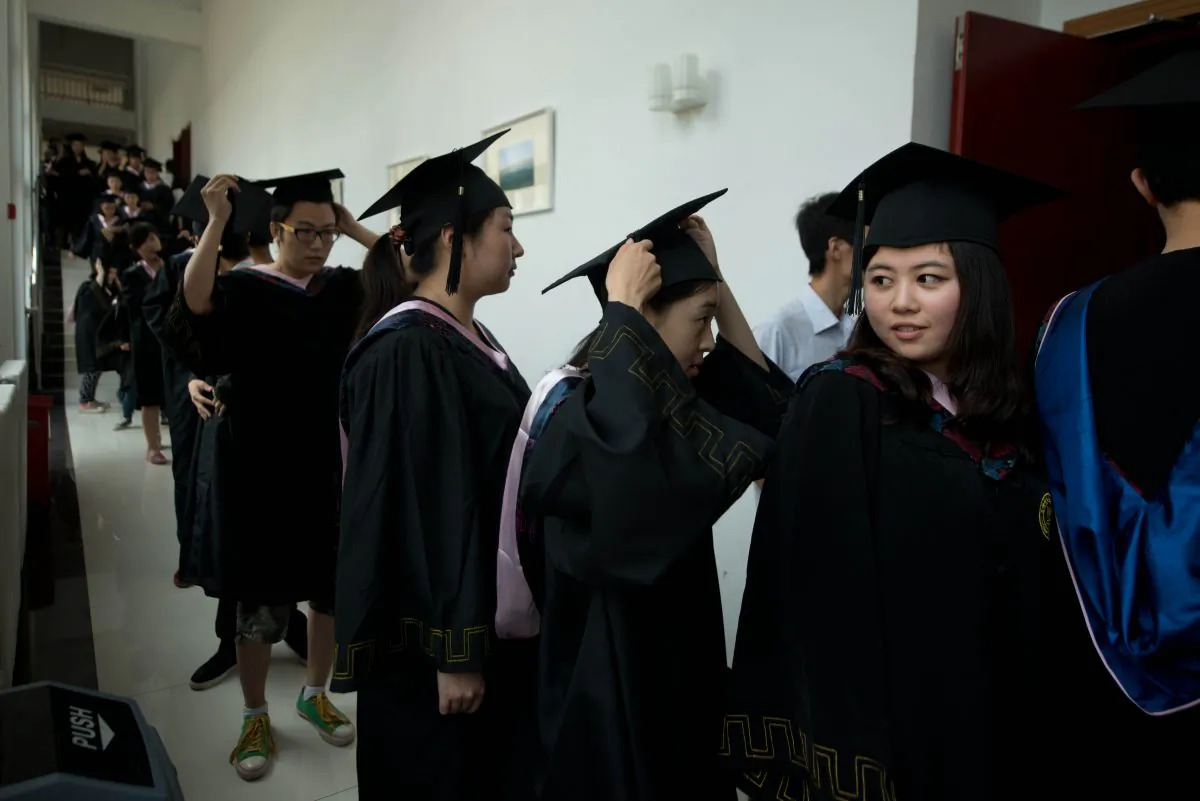 Students line up to receive their degree certificates at the Kade College Capital Normal University on the outskirts of Beijing on June 26, 2013. (Ed Jones/AFP/Getty Images)