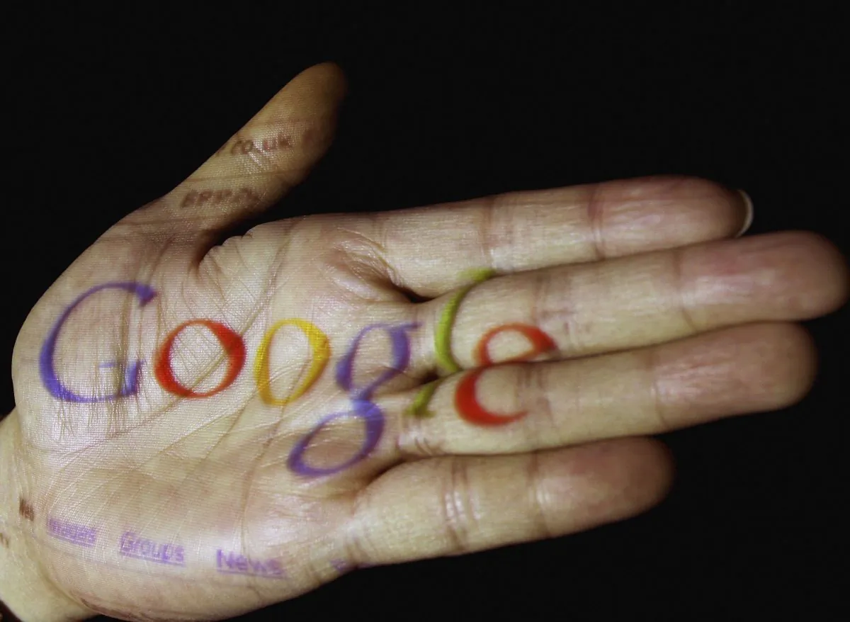 In this photo illustration, the logo of the multi-faceted internet giant Google is seen projected onto the palm of a hand in Glasgow, Scotland.  (Jeff J. Mitchell/Getty Images)