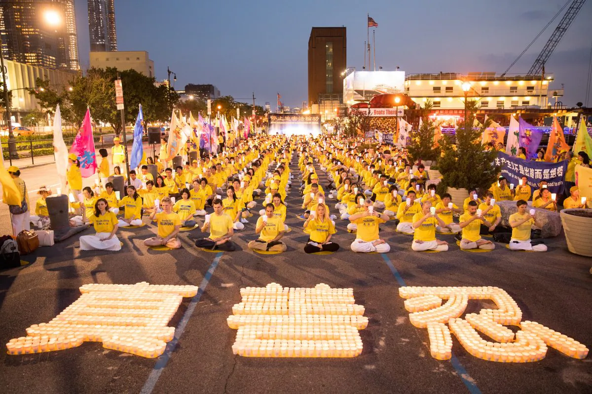 New York Falun Gong practitioners at a candlelight vigil commemorating the 19th anniversary of the Chinese regime's persecution of the Falun Gong spiritual practice, in Manhattan, New York City, on July 16, 2018. (Larry Dye/The Epoch Times)