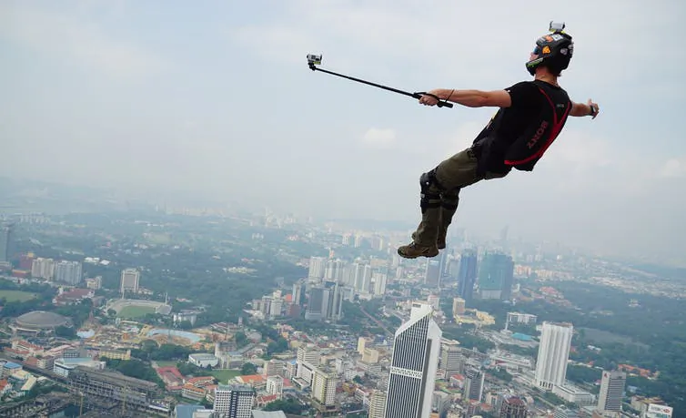 A base jumper takes a selfie over a city in this undated photograph, (shutterstock)
