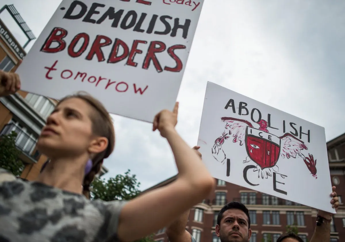 People hold up signs as they protest the U.S. Immigration and Customs Enforcement agency (ICE) and the recent detentions of illegal immigrants, in Washington, on July 16, 2018. (ANDREW CABALLERO-REYNOLDS/AFP/Getty Images)