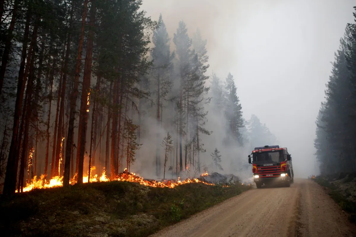 A fire vehicle is seen as fire burns in Karbole, Sweden, on July 15, 2018. (Mats Andersson/AFP/Getty Images)