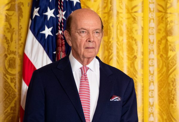 Commerce Secretary Wilbur Ross with American flag in the background
