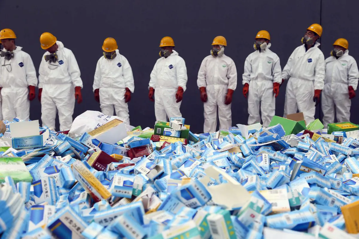 Chinese workers preparing to destroy fake medicines seized in Beijing, on March 14, 2013. The U.S. Food and Drug Administration announced on July 13, 2018 the recall of the heart medicine valsartan, made by Chinese firm Zhejiang Huahai, which was found to be contaminated by a carcinogen. (STR/AFP/Getty Images)