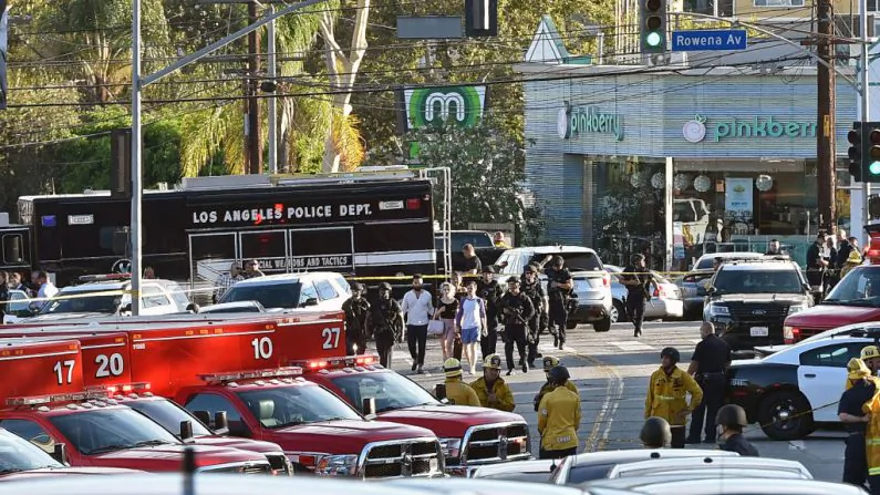 Police officers escort people after a suspect barricaded himself inside a Trader Joe's supermarket in the Silver Lake neighborhood of Los Angeles, on July 21, 2018. (Robyn Beck/AFP/Getty Images)