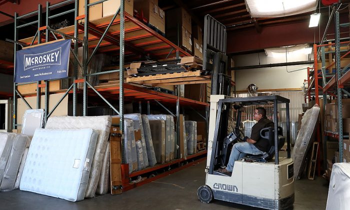 A worker operates a forklift at McRoskey Mattress Company in San Francisco, California on Aug. 9, 2016. Investment in new machinery has dropped from 8 percent of GDP in the 1970s to around 6 percent of GDP today, according to JPMorgan Chase. (Justin Sullivan/Getty Images)