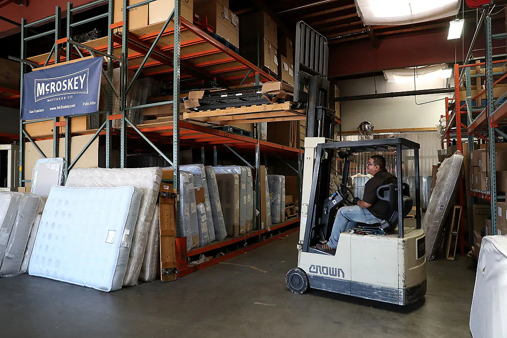 A worker operates a forklift at McRoskey Mattress Company in San Francisco, California on Aug. 9, 2016. Investment in new machinery has dropped from 8 percent of GDP in the 1970s to around 6 percent of GDP today, according to JPMorgan Chase. (Justin Sullivan/Getty Images)