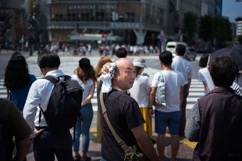 A man wipes perspiration from his head in Tokyo on July 24, 2018, as Japan suffers from a heatwave. (MARTIN BUREAU/AFP/Getty Images))