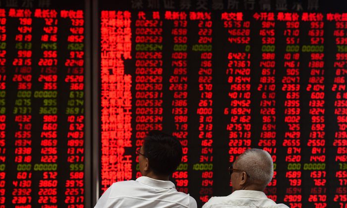 Investors monitor stock price movements at a securities company in Beijing on June 15, 2016. (Greg Baker/AFP/Getty Images)