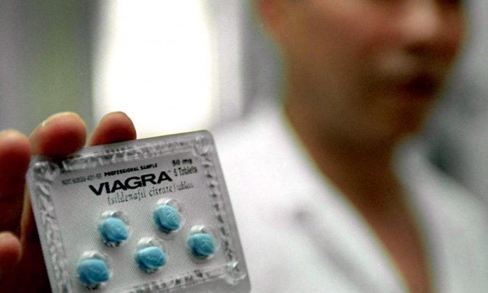 A file photo of a doctor showing the anti-impotence drug Viagra (Sildenafil Citrate) at a hospital in Shanghai in this file photo. (Liu Jin/AFP/Getty Images)